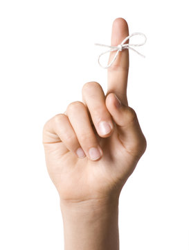 Right hand with reminder string tied to index finger