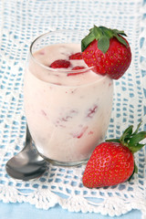 Glass of strawberry yoghurt, with strawberries,