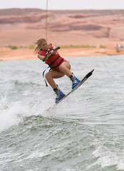 Pretty girl wakboarding with beautiful Lake Powell