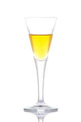 Glass of yellow paradise cocktail reflected on white background