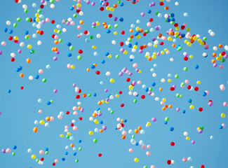 colored balloons flying up in the sky