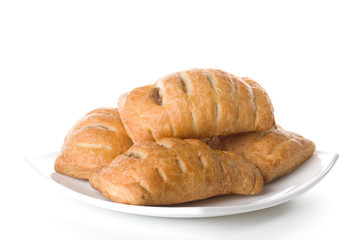 Fresh rolls on a plate on a white background