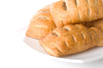 Fresh rolls on a plate on a white background