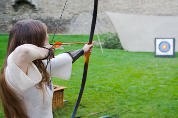 Beauty girl bends bow archer target arrow