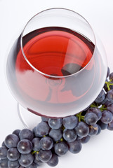 Glass of Red Wine and Purple Grapes