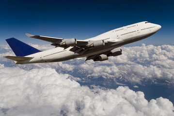 Fototapeta premium Flugzeug über den Wolken