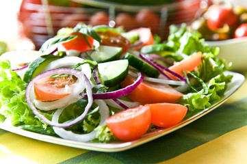 Fresh salad with onion, tomato and basil