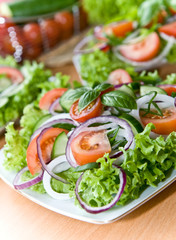 Fresh salad with onion, tomato and basil