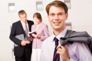 Portrait of confident boss holding his jacket