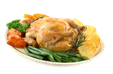 Whole roast chicken with potatoes pumpkin carrots and beans.