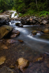 Little cascade of waterfalls in a peaceful wood.