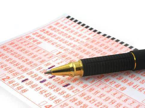 close-up of lottery ticket and ballpoint pen