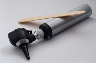 Otoscope and tongue depressor