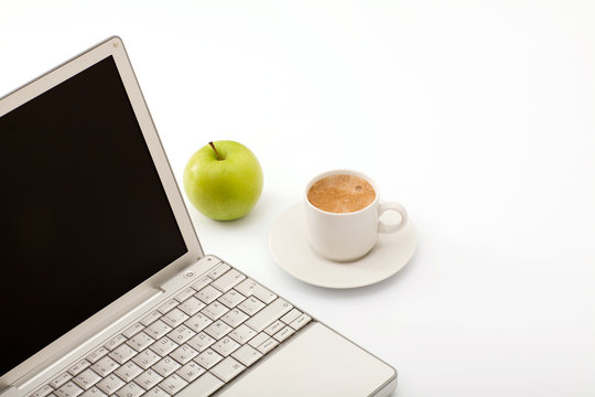 notebook, green apple and cup of coffee