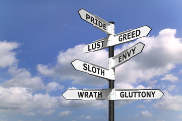 Concept image of a signpost with the seven deadly sins - 9227720