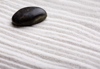 Fototapeta na wymiar A rock in beautifully styled white sand