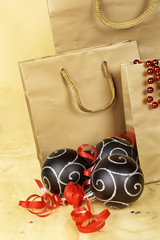Christmas decoration with balls and bags, over yellow background