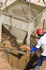 Construction worker pouring concrete from container (1)