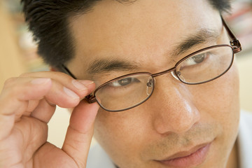 Man Looking Through New Glasses