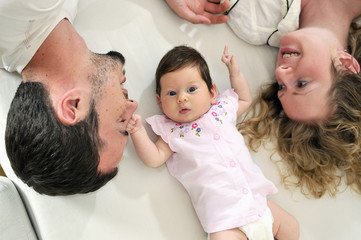 Obraz premium indoor portrait with happy young family and cute little babby