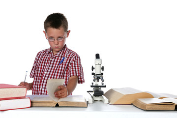 child scientist in glasses consulting his books