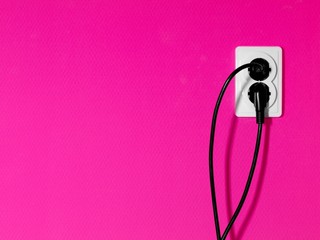 Electric oulets on magenta colored wall