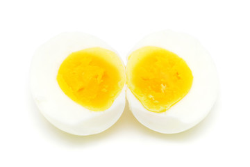 Cooked egg sliced into half isolated on white background.