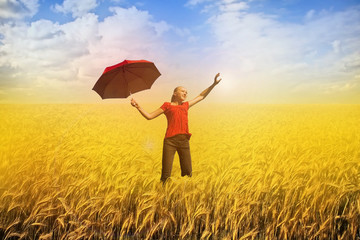 happiness and freedom - woman with red umbrella on field