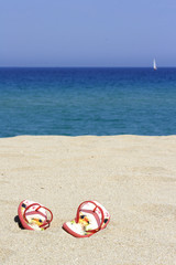 flips flops on an empty sandy beach, Corsica, France
