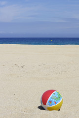 a beachball on empty sandy beach in Corsica