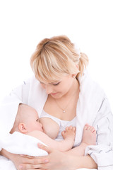 Obraz na płótnie Canvas Mother breast feeding her baby girl. Isolated on white