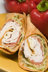turkey and swiss cheese wrap sandwich with red bell peppers