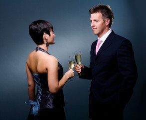Couple drinking champagne on a party.