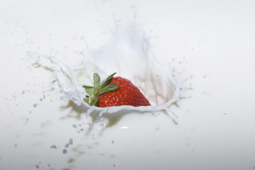 splashing strawberry into a milk