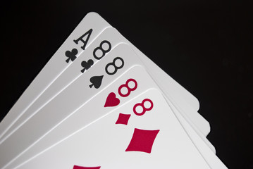 Royal Flush held by hand against black background
