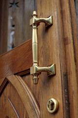 Old-fashioned frazzle brass door handle close up
