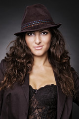 smiley woman in hat over dark background