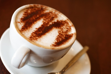 wonderful cappuccino coffee in white cup, shallow DOF