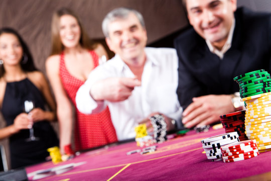 Image of people staking with pile of different chips