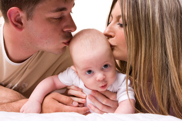 Happy three month baby with parents