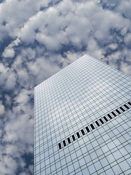 High modern skyscraper on a background of a blue sky and clouds.