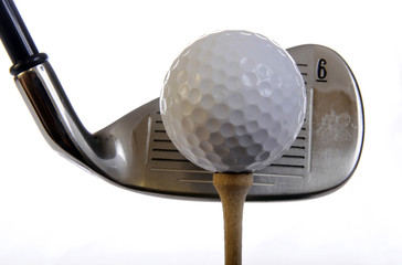 Golf club with ball on a tee isolated