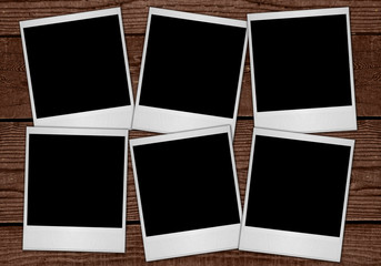 Multiple Polaroid Film Blanks Sitting on Wood Background