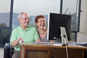 senior couple using an imac computer