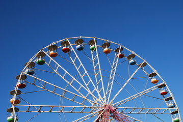 Ferris wheel on background blue sky