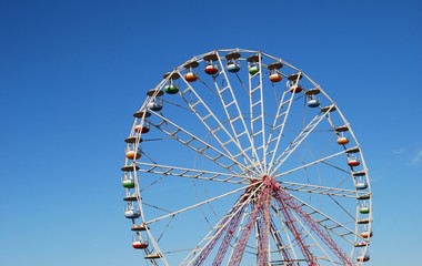 Ferris wheel on background blue sky