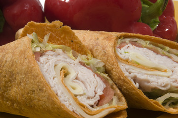 turkey and swiss cheese wrap sandwich with red bell peppers