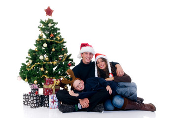 Christmas, happy couple with son, child next to Xmas tree