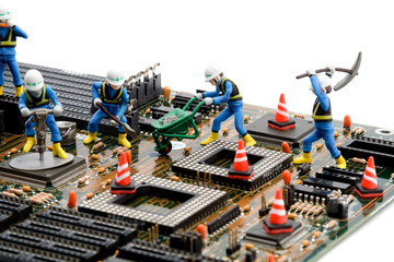 construction site - little workers repairing motherboard