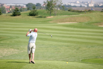 Golfer in bussy saint georges hole 7, france, hitting shot